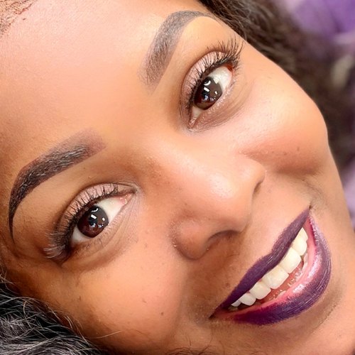 Client smiling after brow shaping and tint, Houston TX