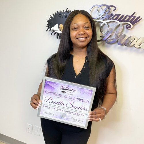 Student with her permanent makeup training certificate