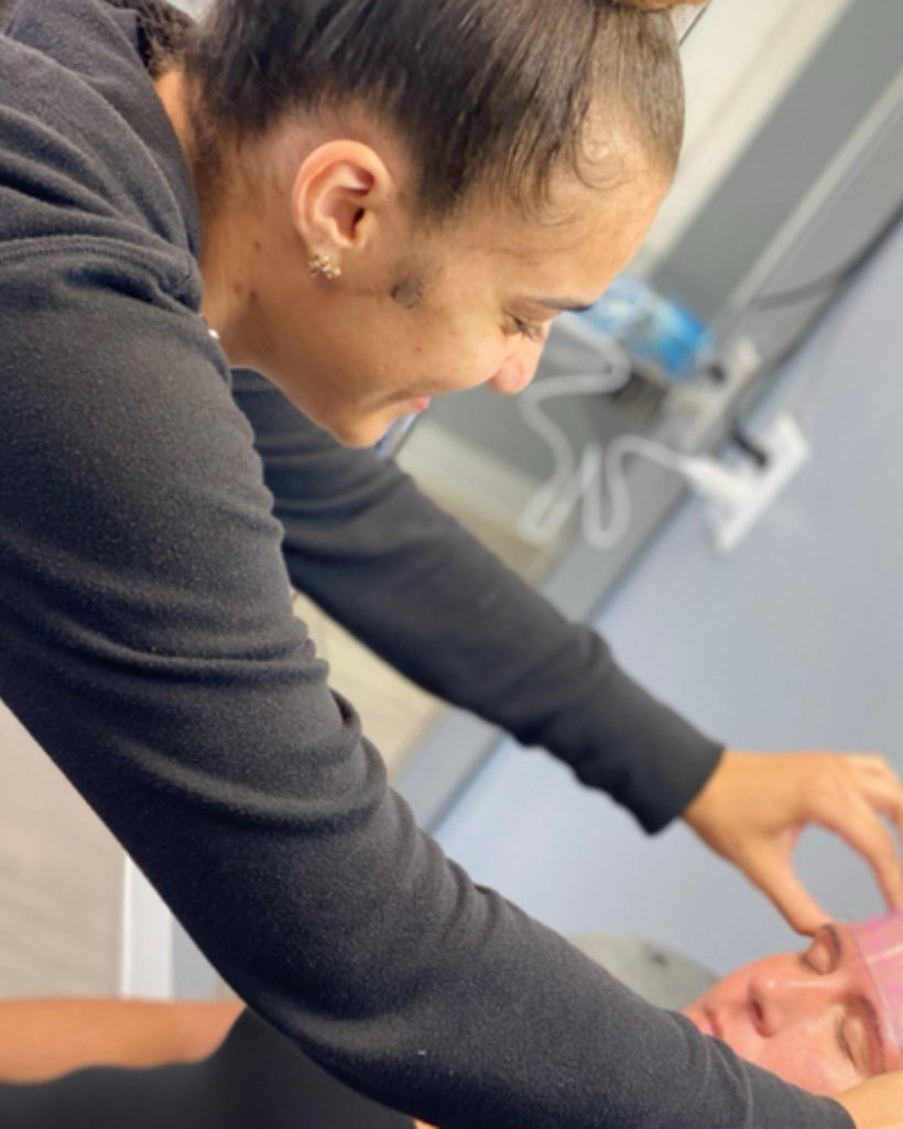 LaSheen mapping a client's brows at her private studio in Houston, TX